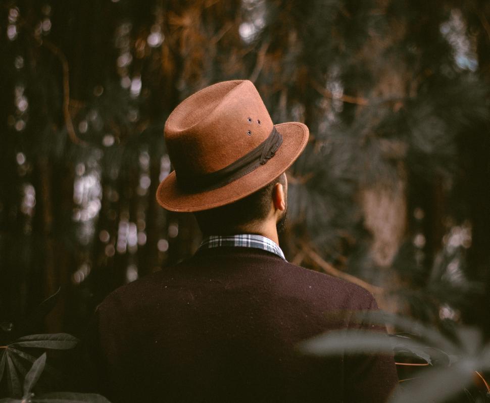 Free Image of Man wearing a hat in a forest setting during autumn 