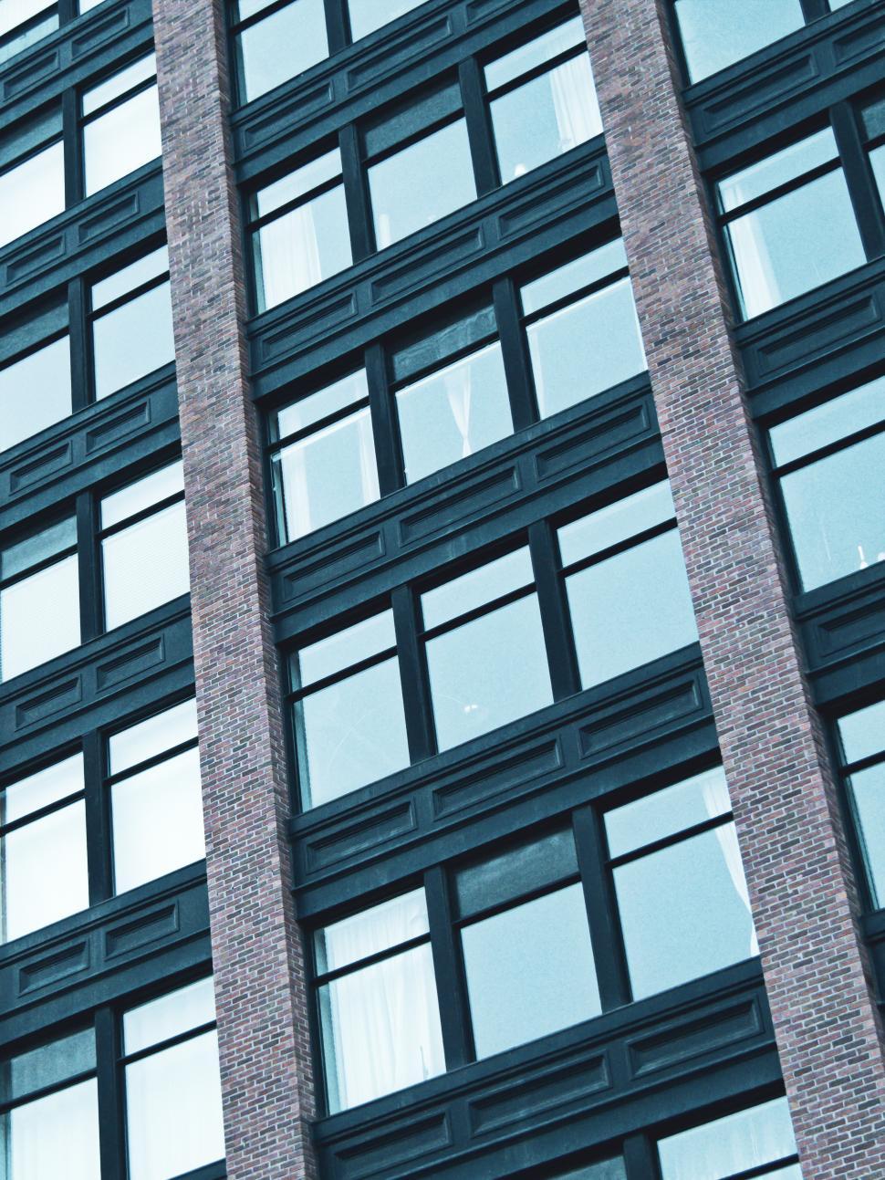 Free Image of Modern building facade showcasing repeating windows and brick details 
