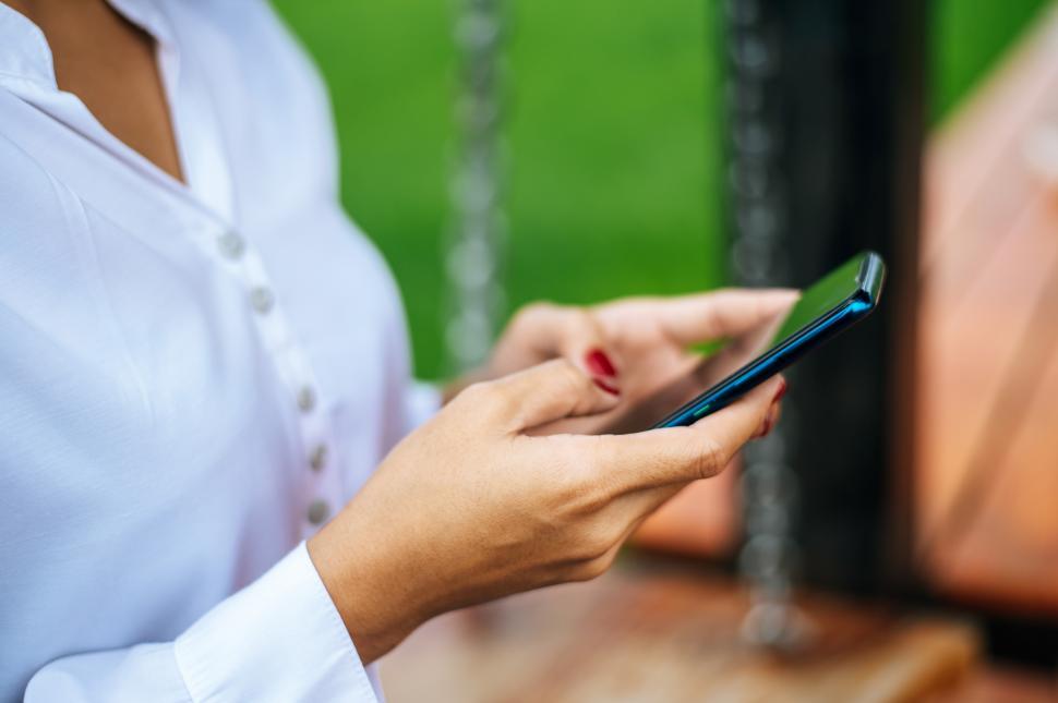 Free Image of woman standing on a smartphone 