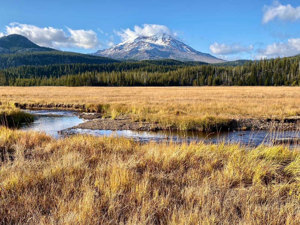 Free Image of Mountain landscape with grassy fields and clear blue sky 