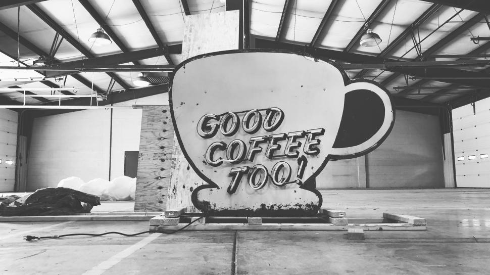 Free Image of Coffee cup sign inside a spacious industrial building 