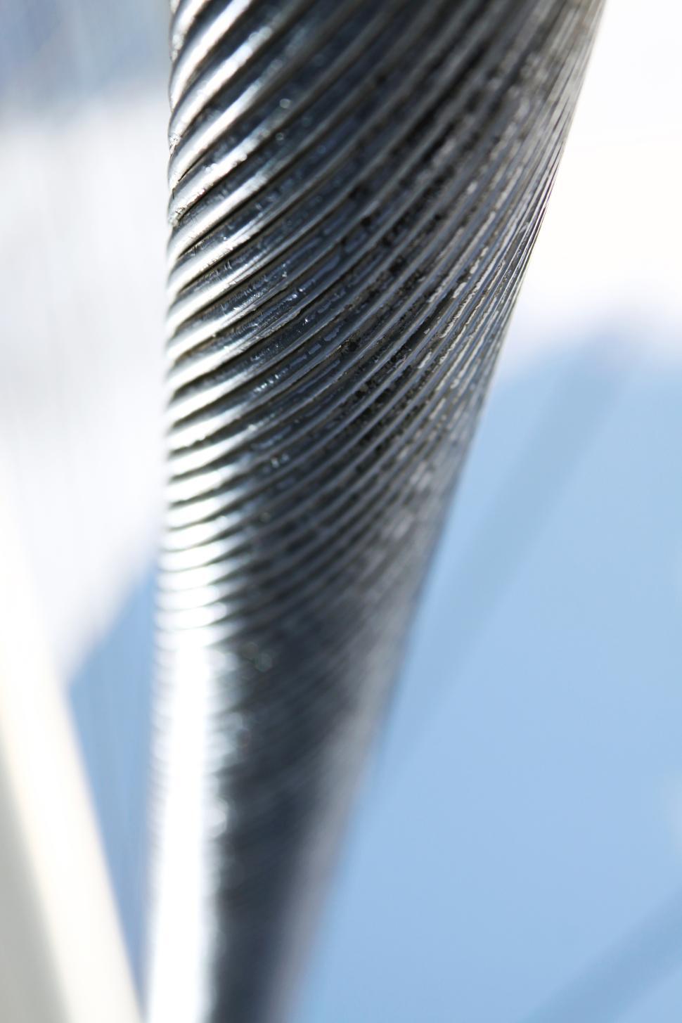 Free Image of Close-up view of a metallic spiral structure against a blue background 