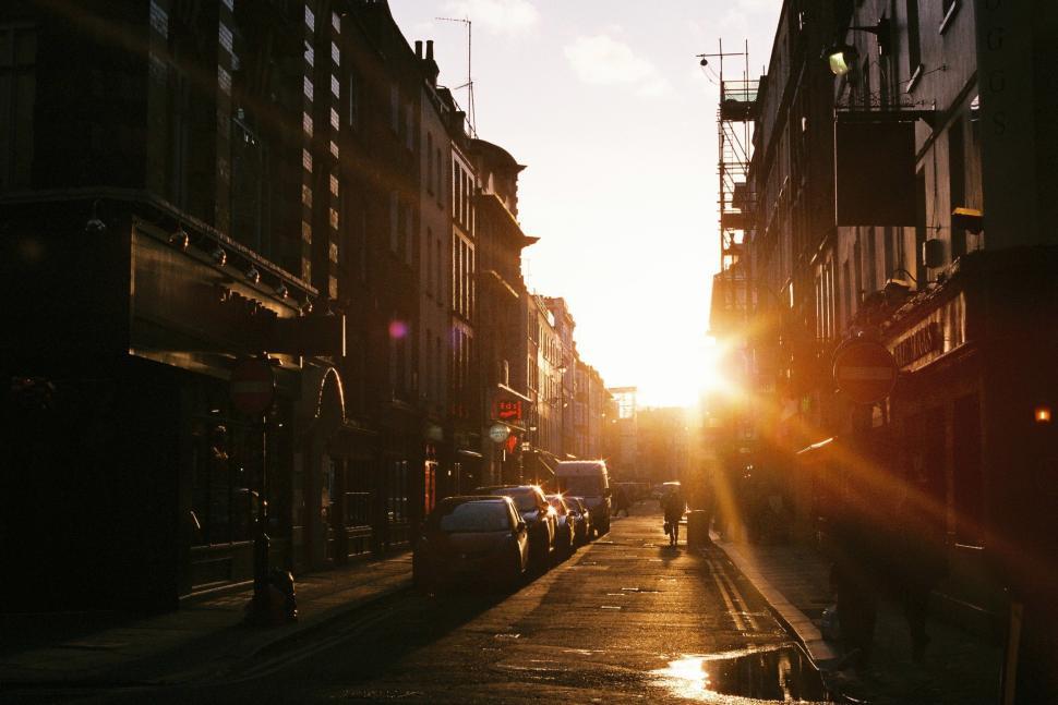 Free Image of Sunset casts warm glow on quiet street in urban neighborhood during evening 