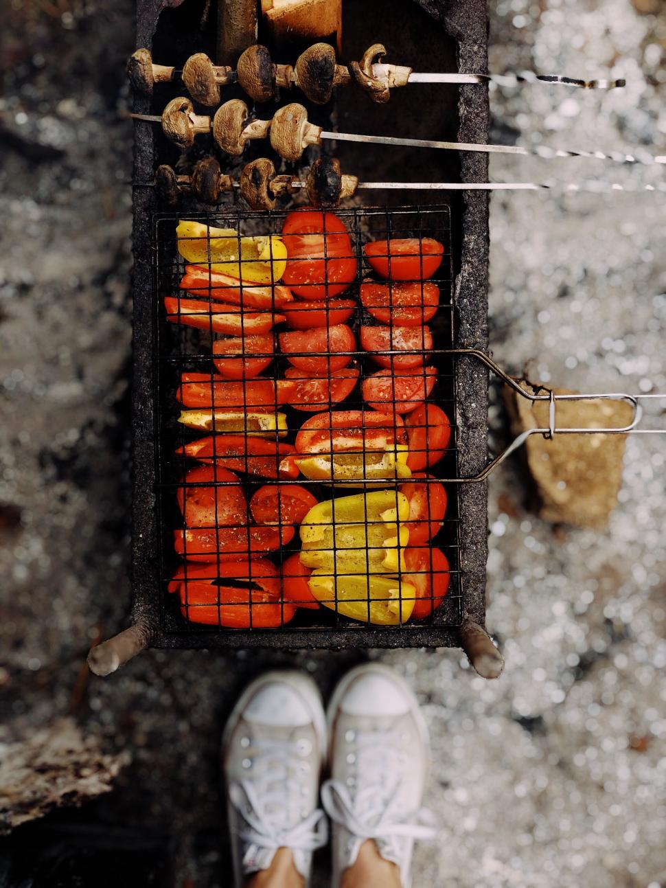 Free Image of Grilling colorful vegetables on a barbecue in a cozy outdoor setting 
