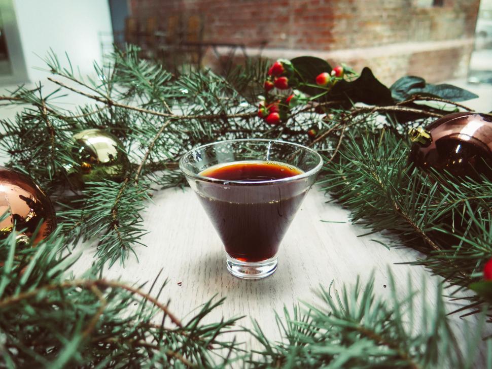 Free Image of Holiday drink served in a festive setting with greenery and ornaments 