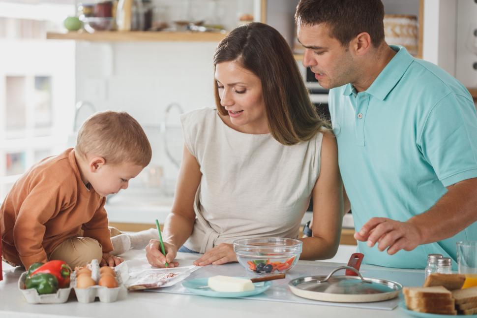 Free Image of Family cooking together in a modern kitchen during afternoon 