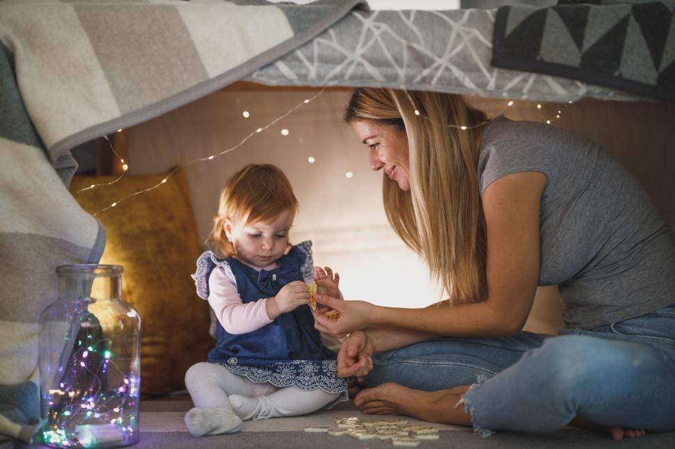 Free Image of Creating fun memories while playing together in a cozy fort 