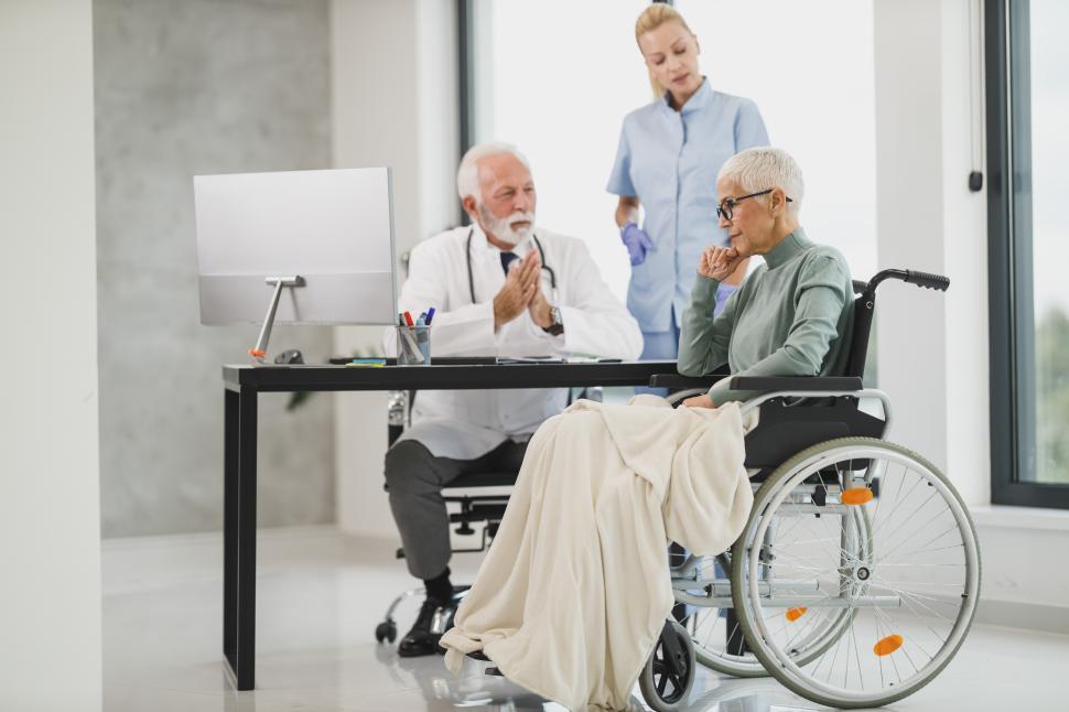 Free Image of Doctor discusses health concerns with patient in modern clinic 