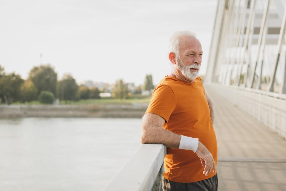Free Image of Senior man exercises on bridge while enjoying fresh air 
