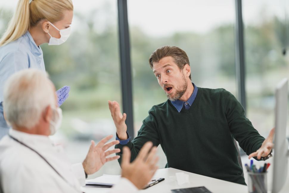Free Image of Tense conversation in a modern healthcare office setting during consultation 
