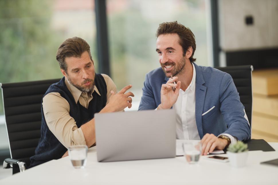 Free Image of Two professionals discussing ideas during a meeting in a modern office 