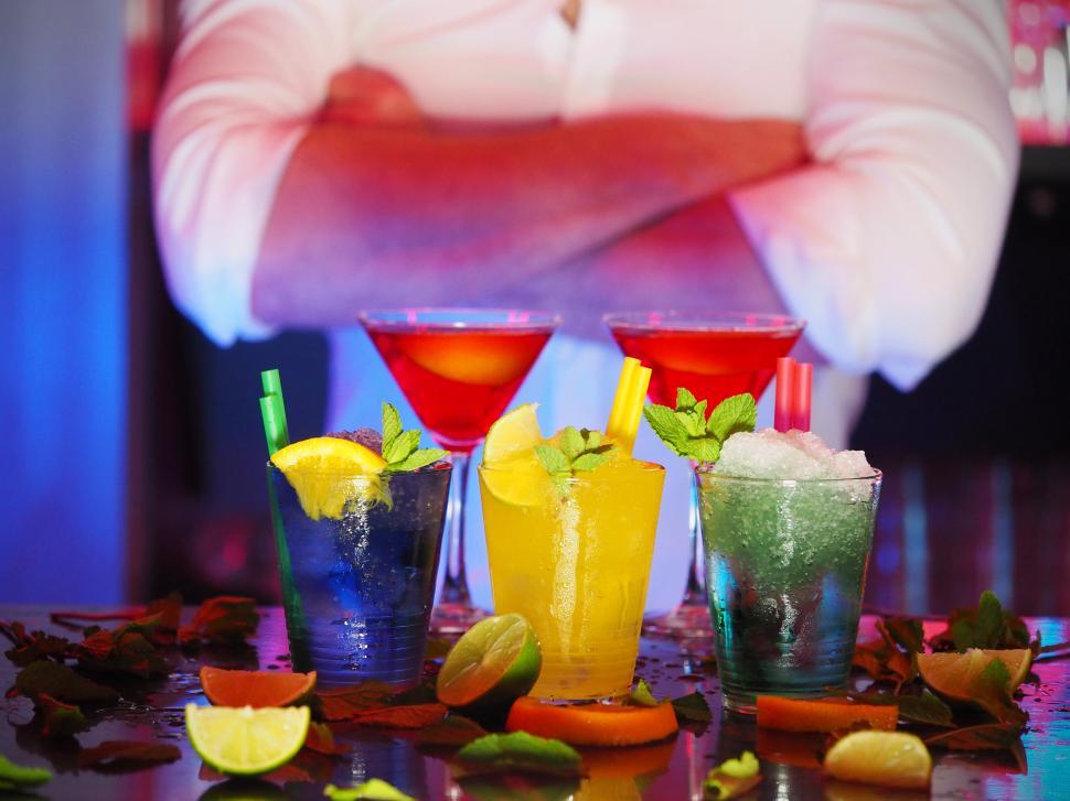 Free Image of Colorful cocktails display at a lively bar during a festive night out 
