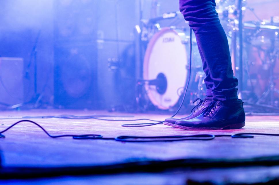 Free Image of Musician performs on stage with captivating lighting effects 