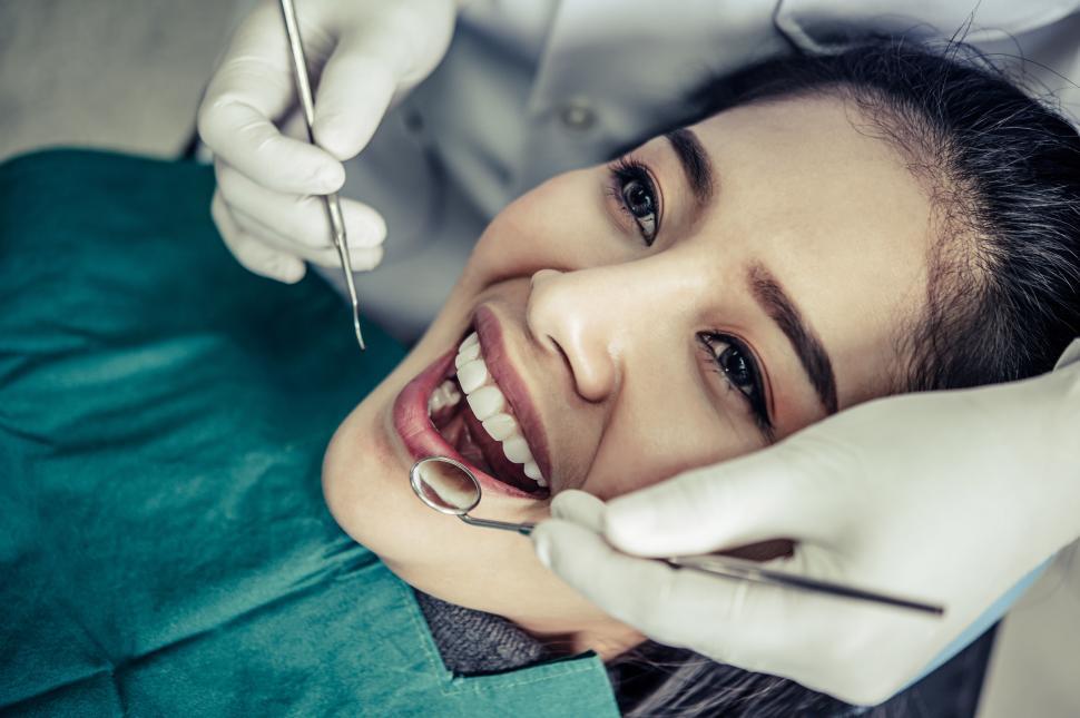 Free Image of Dentist treats patients teeth. 
