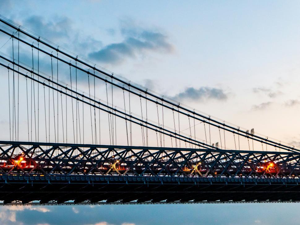 Free Image of Evening lights illuminate bridge under clear sky with soft clouds 
