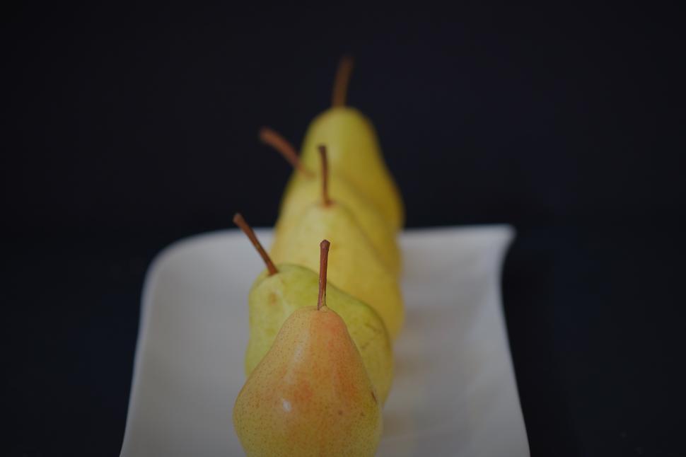Free Image of Colorful collection of pears arranged on a plate 