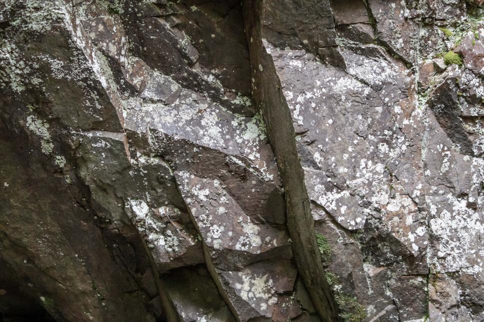 Free Image of Natural rock formation showcasing textures and patterns in a shaded area 