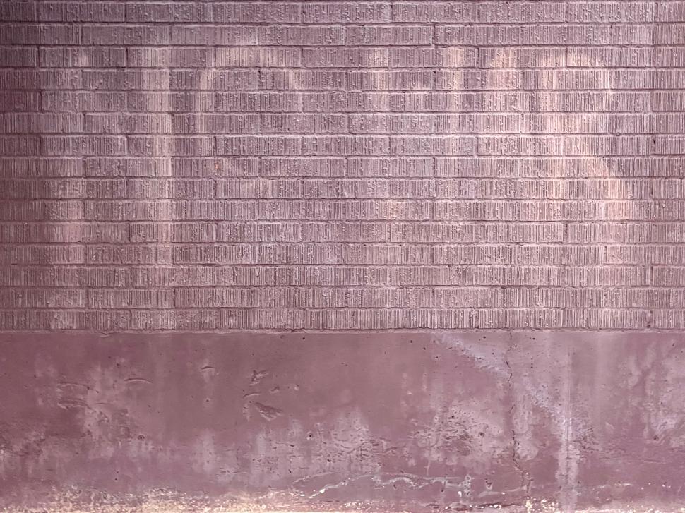 Free Image of Weathered wall with faded No War lettering near a city street in afternoon light 
