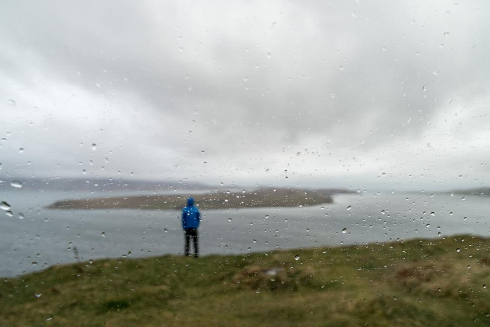 Free Image of Rainy day at the coast with a solitary figure 