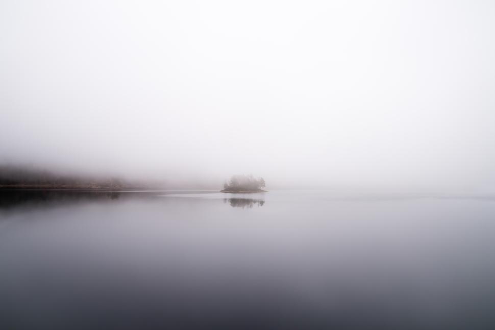 Free Image of Mist blankets a serene lake at dawn 