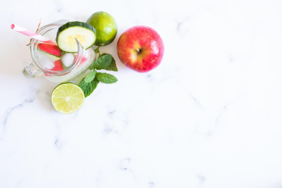 Free Image of Refreshing drink with fruits and herbs on a marble surface 