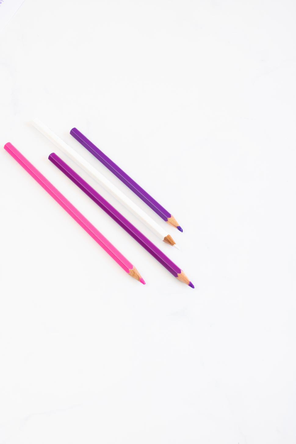 Free Image of Colorful pencils arranged on a white surface 