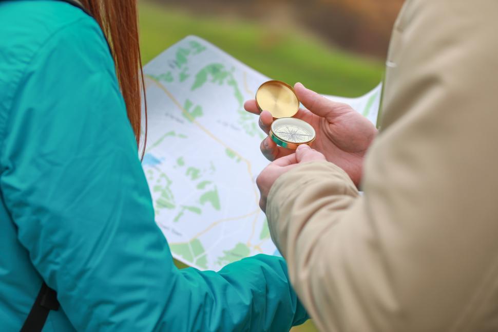 Free Image of Exploring nature with a compass and map in a serene location 