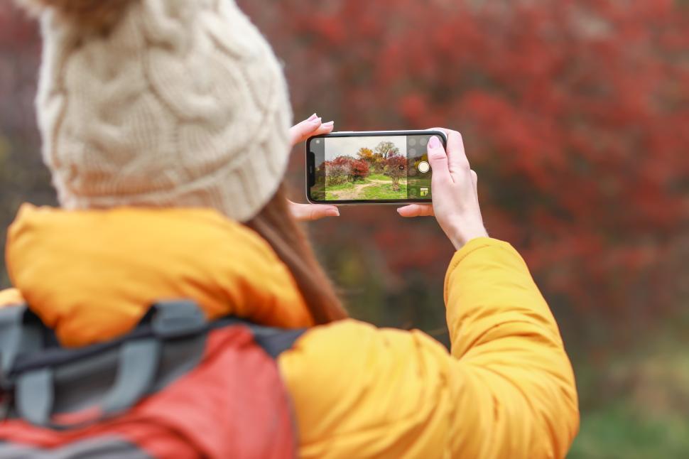 Free Image of Capturing autumn colors during a nature walk in a vibrant park 