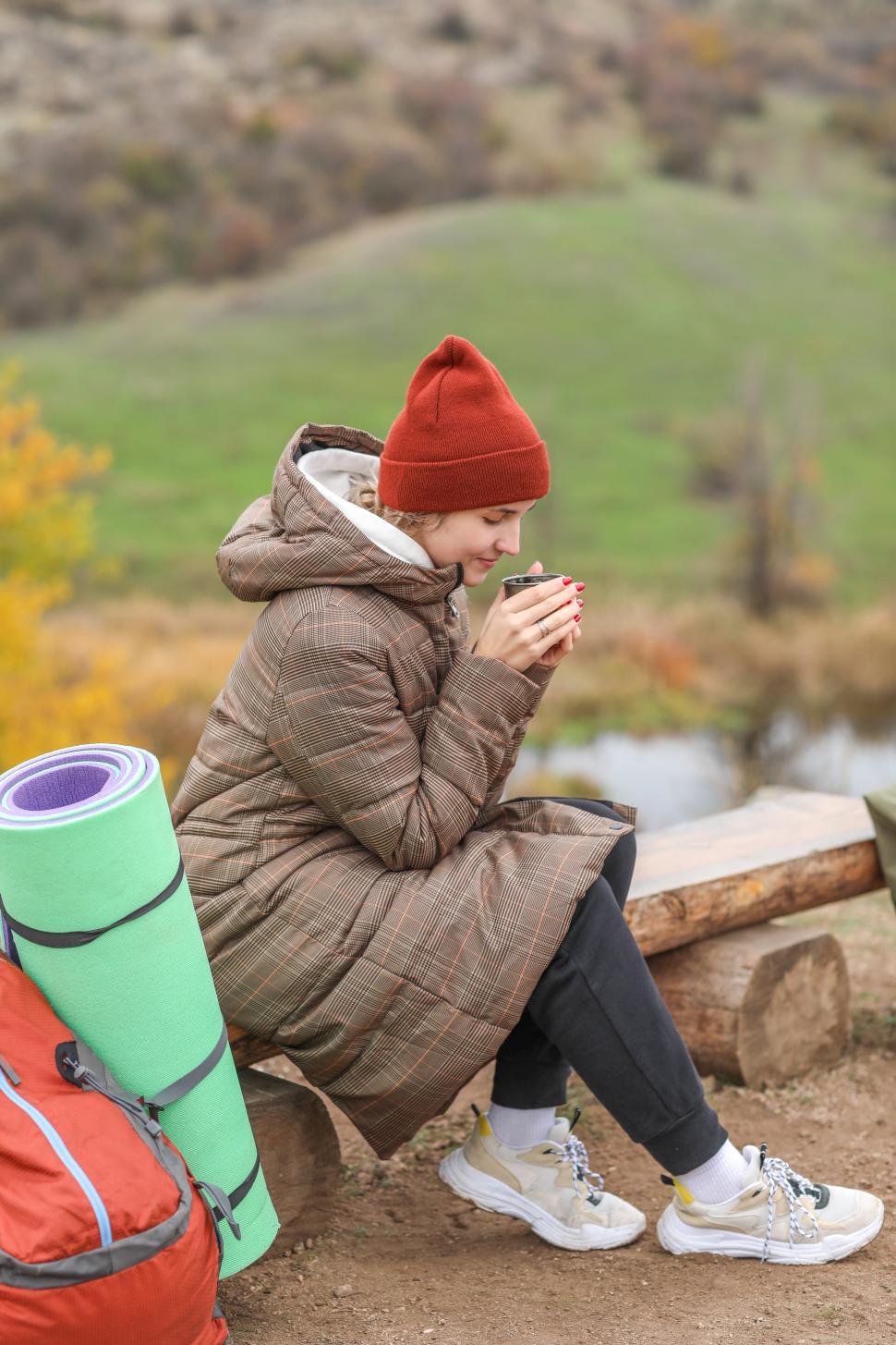 Free Image of Enjoying warm drink in nature during autumn hike 