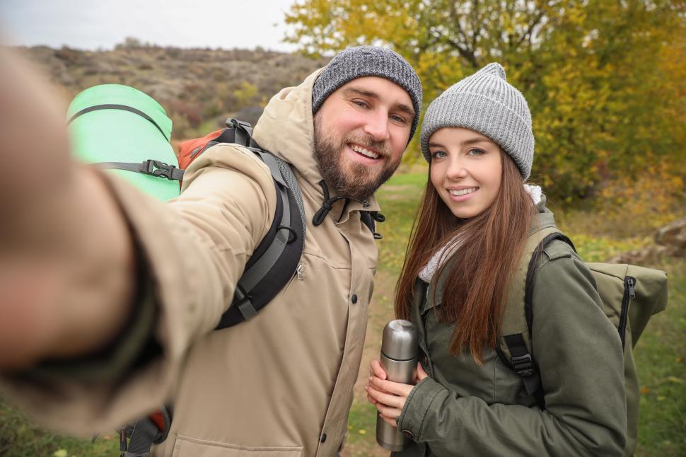 Free Image of Couple enjoying a hiking adventure in a picturesque landscape 