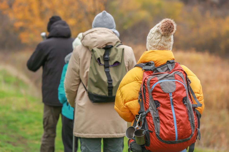 Free Image of Hikers exploring autumn landscape on a cool day in nature 