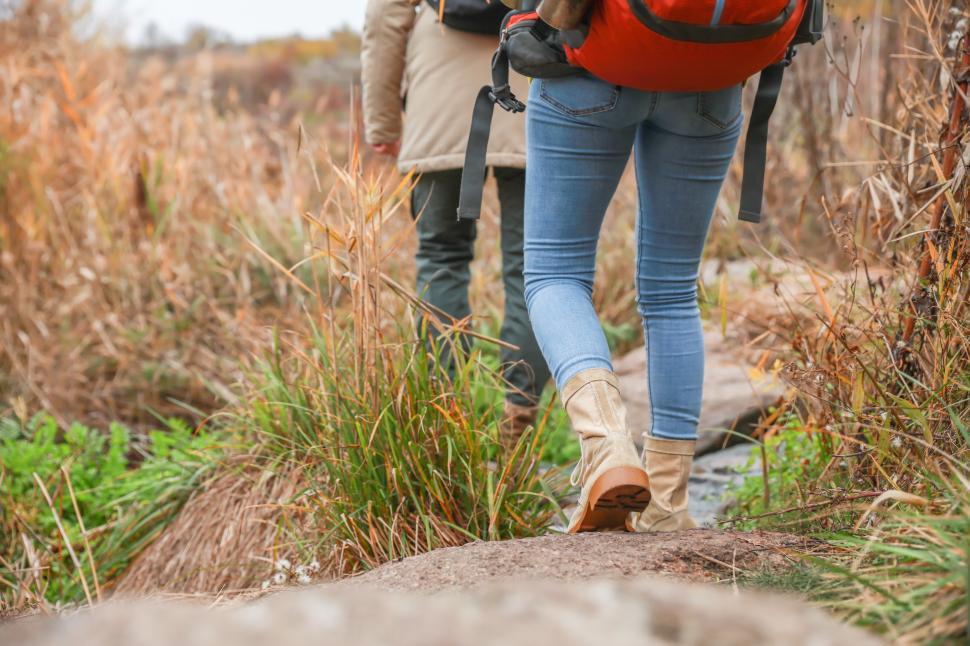 Free Image of Enjoying a hike through a grassy trail in autumn 