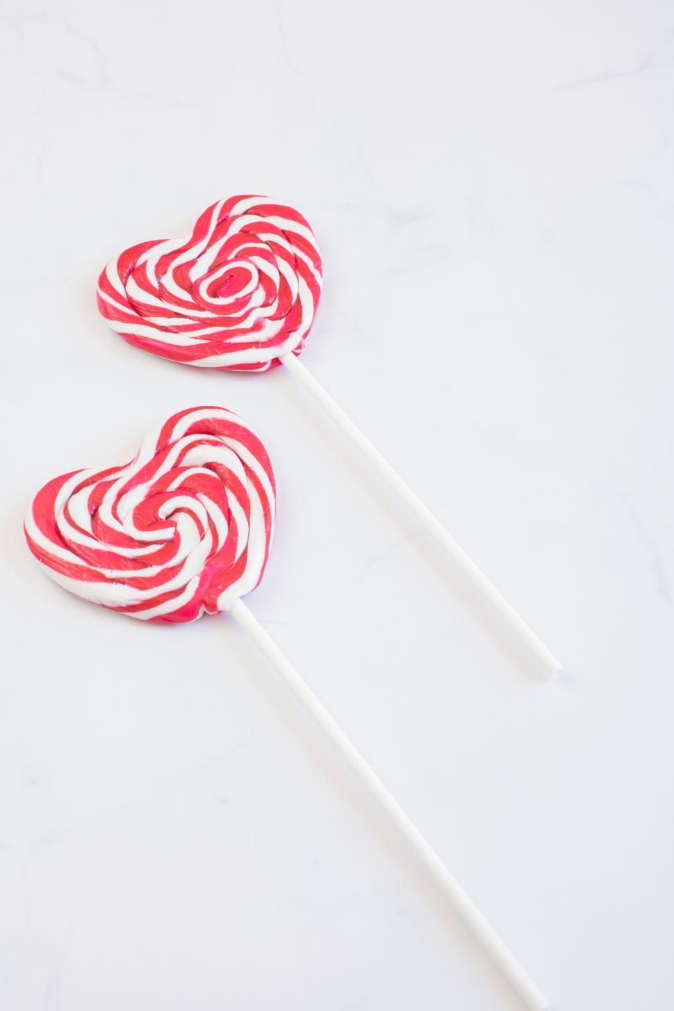 Free Image of Colorful heart-shaped lollipops with swirled patterns 
