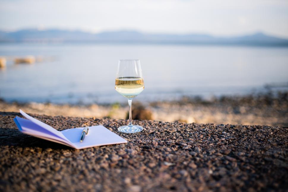 Free Image of Relaxing by the water with wine and a journal 
