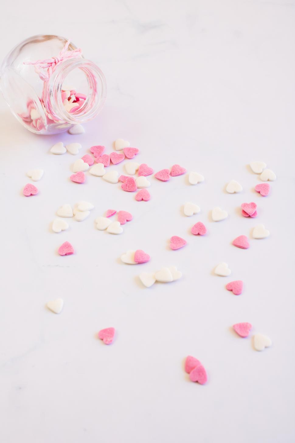 Free Image of Sweet heart-shaped sprinkles scattered on a surface 