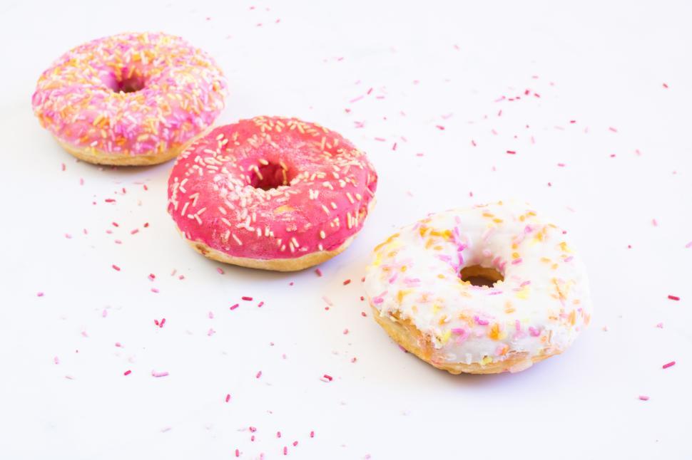 Free Image of Colorful donuts decorated with sprinkles on a white surface 