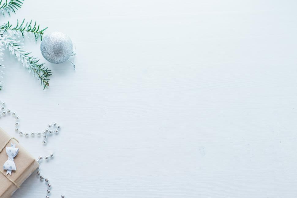 Free Image of Decorative winter arrangement with silver ornaments and gift 