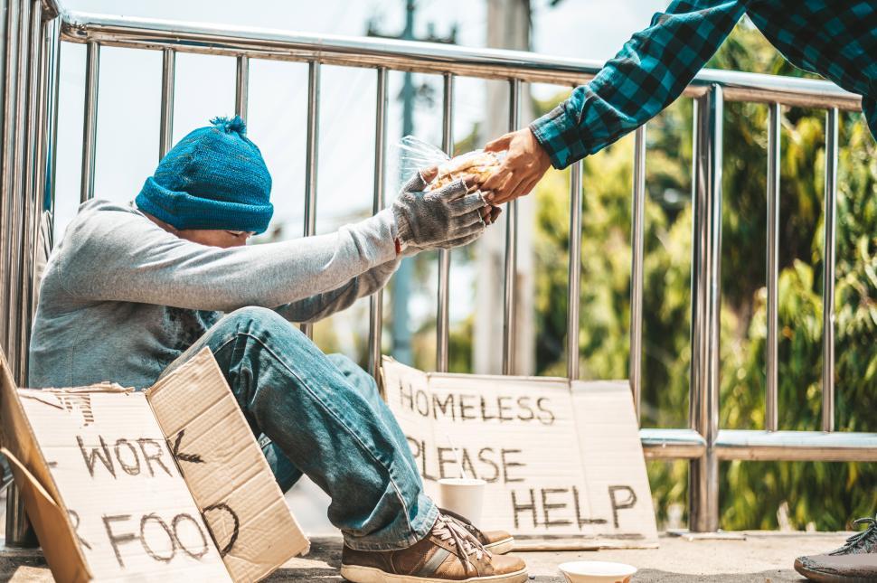 Free Image of The man sitting begging on an overpass. 