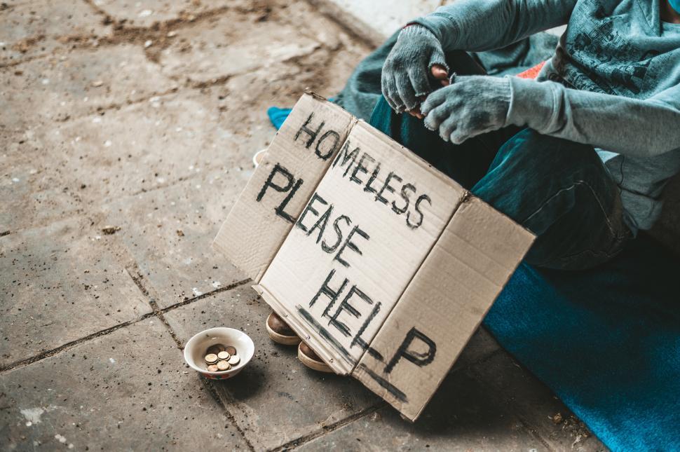 Free Image of The beggars sat beside the street with a homeless message. Please help and work with food. 