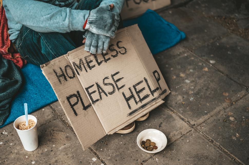 Free Image of The beggars sat beside the street with a homeless message. Please help and work with food. 