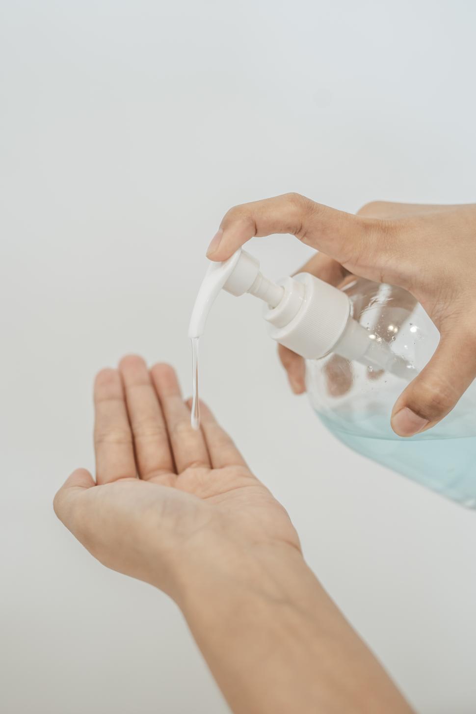 Free Image of Women wearing white shirts that press the gel to wash hands to clean hands. 