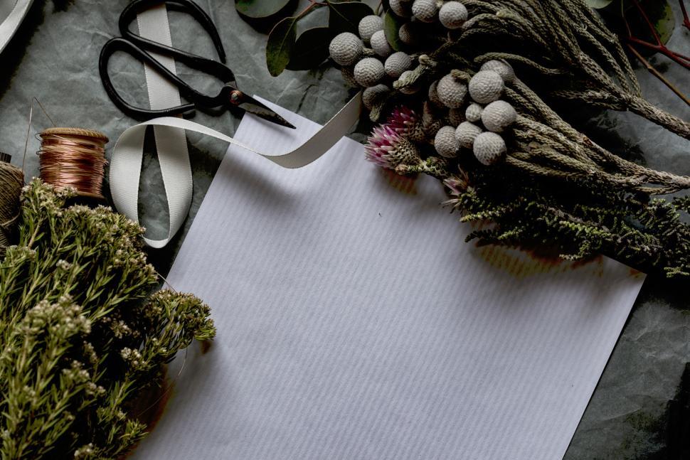 Free Image of Crafting with dried flowers and tools on a work table 