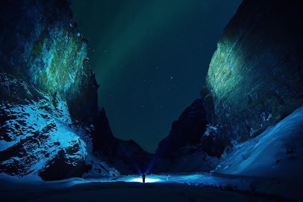 Free Image of Stunning night view of a person in a snow-covered canyon 