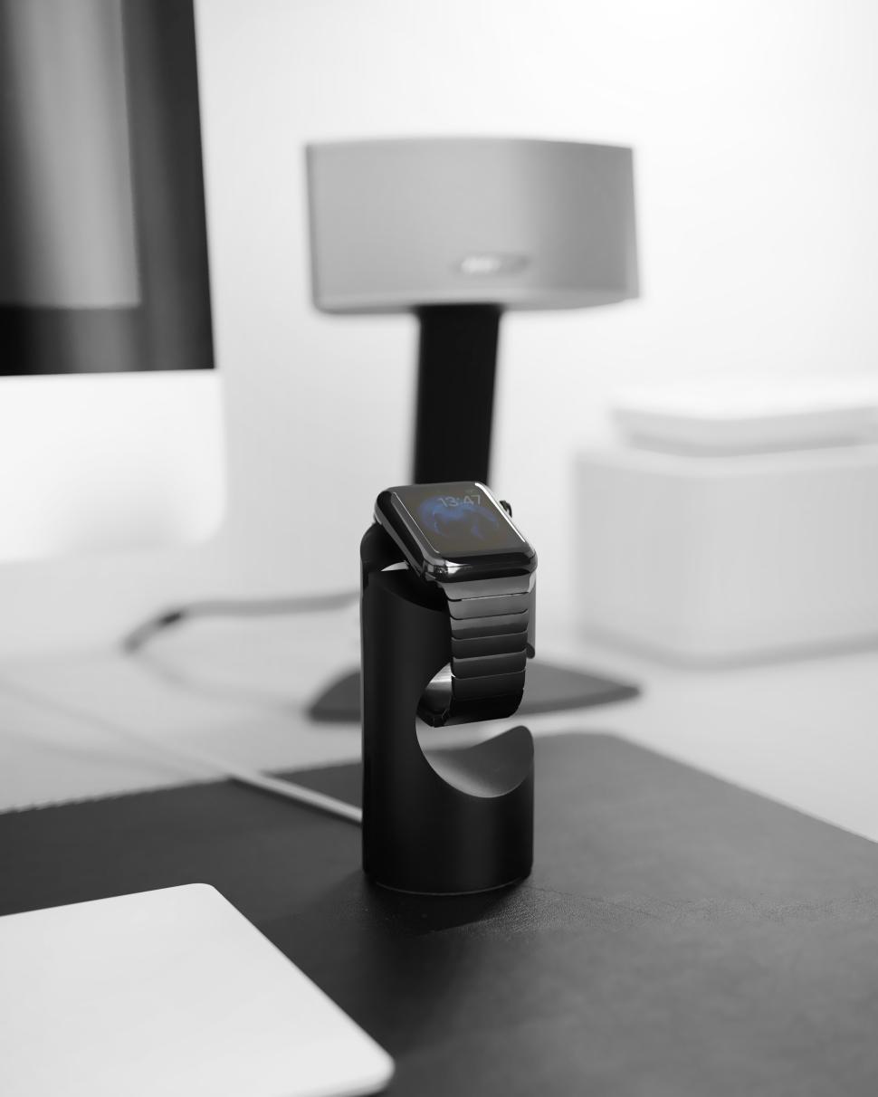 Free Image of Stylish smartwatch charging on a minimalist desk setup 