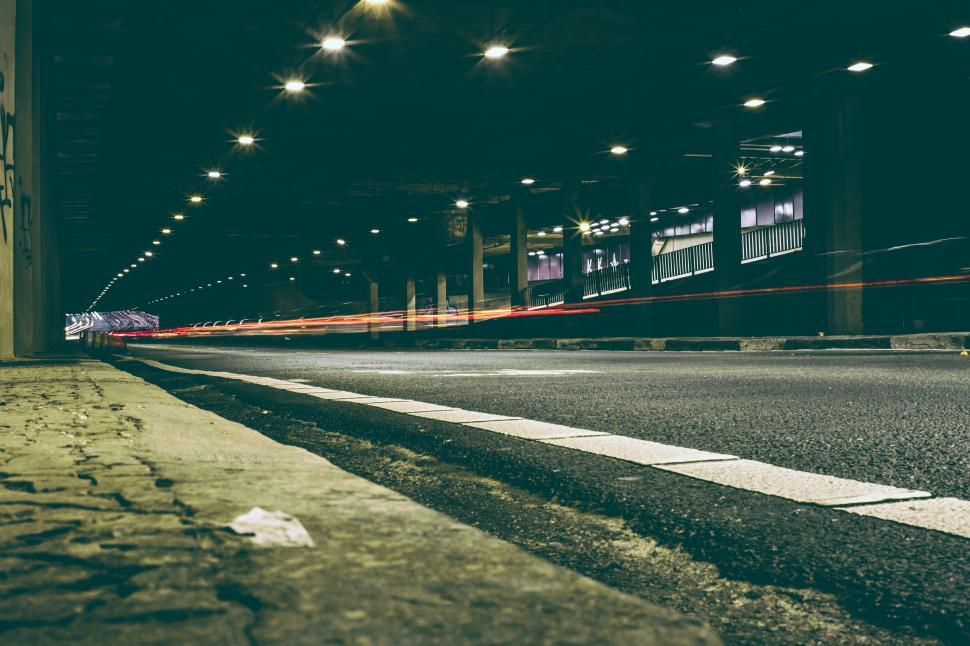 Free Image of Urban tunnel with light trails showcasing fast-moving traffic at night 