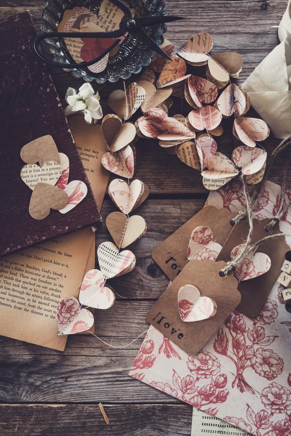 Free Image of Heart decorations made from paper on wooden table for craft project 