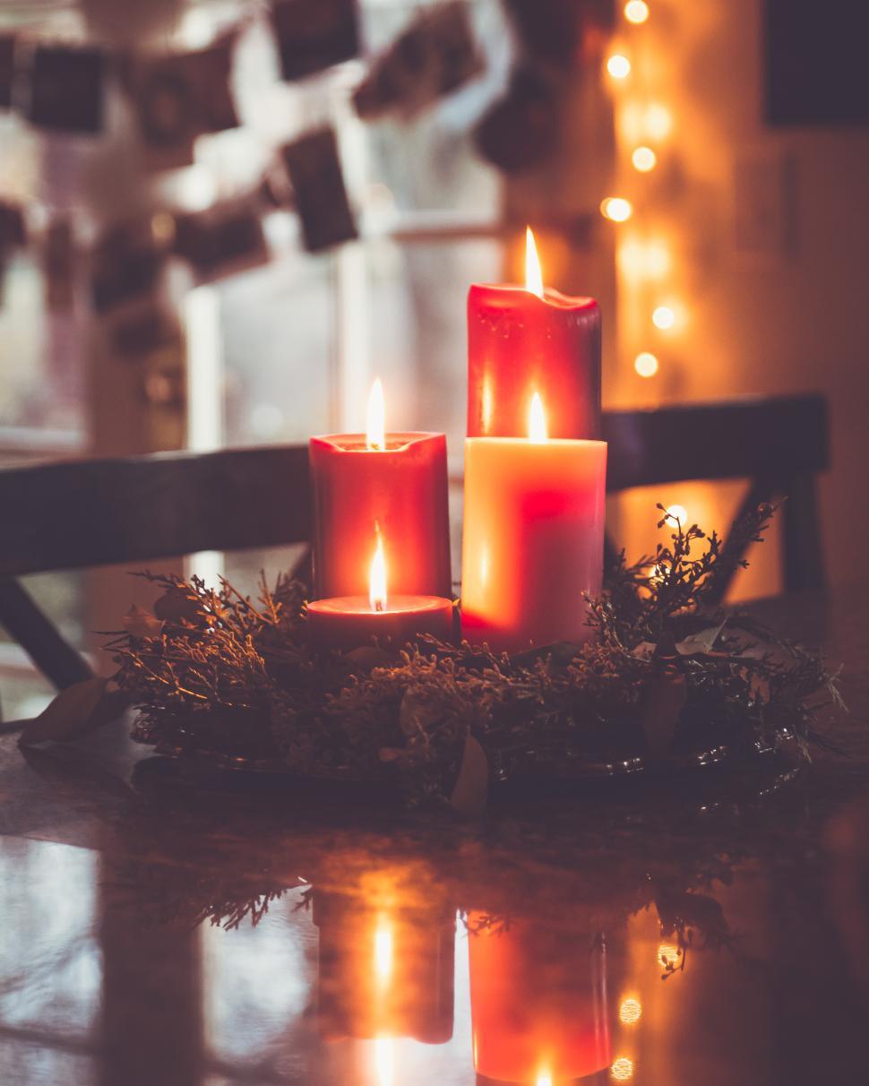 Free Image of Warm candlelight creates a cozy atmosphere in a decorated room for the holidays 