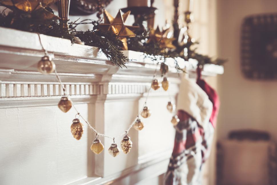 Free Image of Decorative holiday mantel display with garland and ornaments 