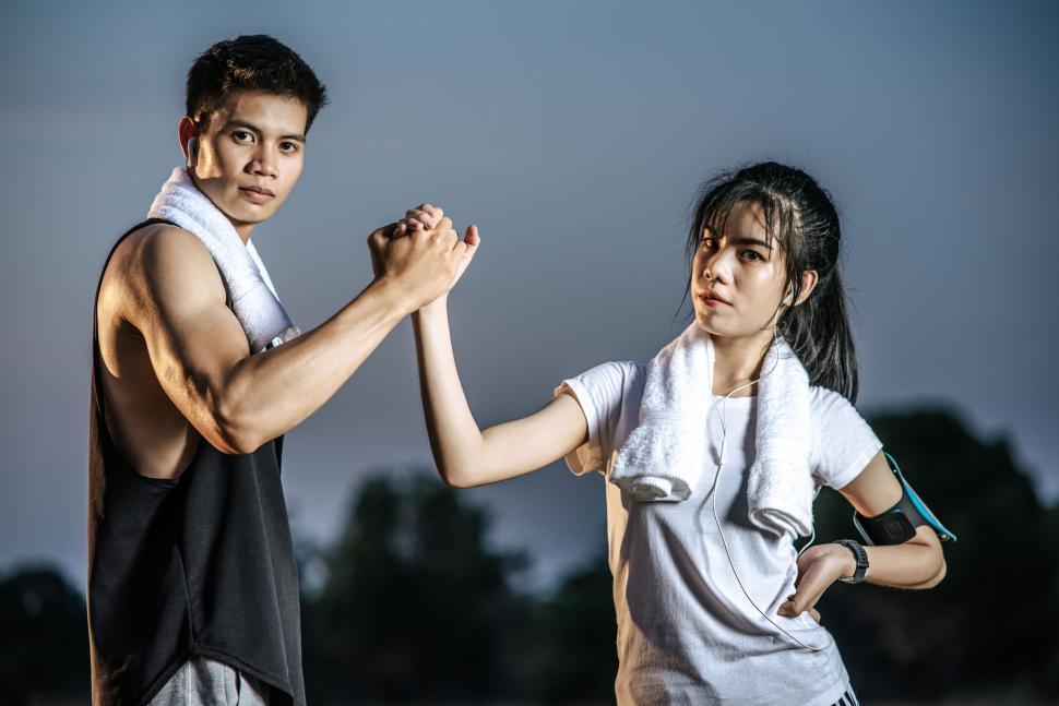 Free Image of Women and men stand holding hands to exercise. 