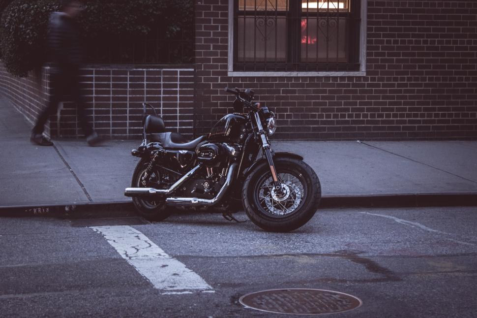 Free Image of Motorcycle parked on city street during evening 